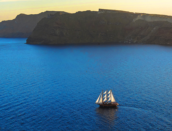 Foto Friday - a sailing ship passing an island at sunset