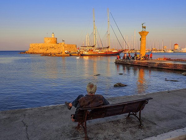 Foto Friday - man on a bench looking at a harbor