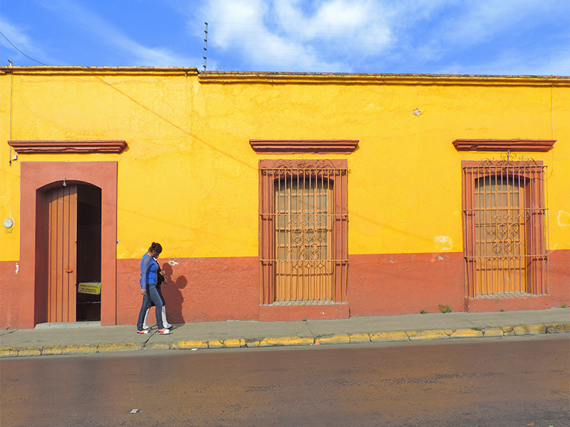 Foto Friday - a woman walking past brightly painted buildings-DSCN1942-600