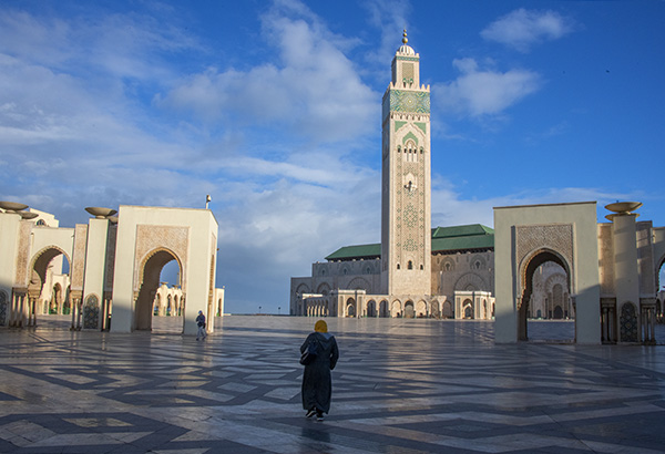 Foto Friday - people walking by a large minaret and mosque