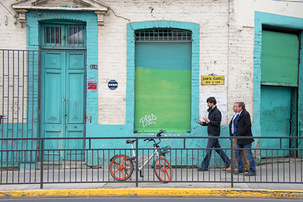 Foto Friday - three men waling past a brightly painted old building