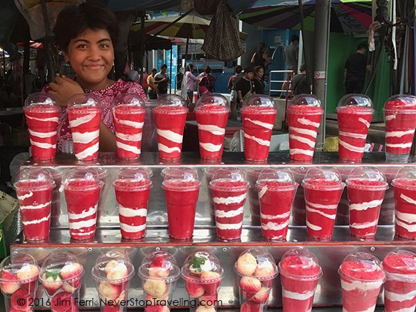 Foto Friday - a young woman selling smoothies ina markey