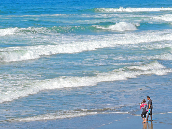 Foto Friday - a family wading along an ocean beach