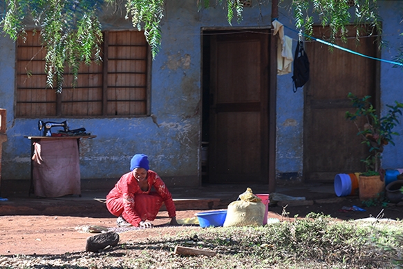 Foto Friday - a woman kneeling outside her home