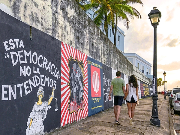 Foto Friday - a couple walking past street art on a building