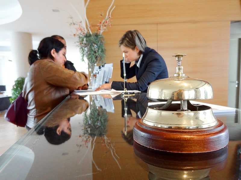 people at a hotel desk at check-in