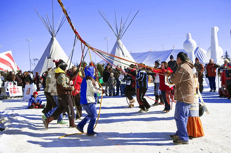 people dancing in the snow at a Canadian winter festival