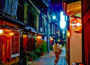 woman walking down a lane at night in Japan