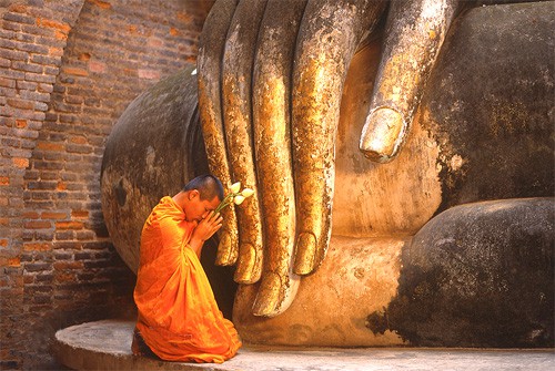 the hand of a large Buddha statue in Sukhothai
