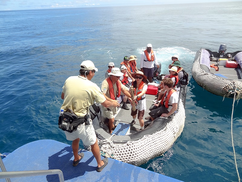 people getting on a ship in the Galapagos Islands