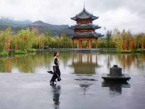 a woman and a pagoda in Lijiang china
