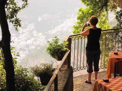 a woman taking a photo from a terrace in Nocelle