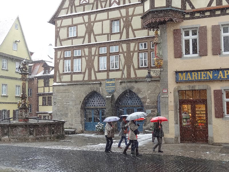 people with umbrellas in Rothenburg Germany