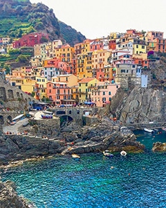 brightly colored houses by a harbor in Cinque Terre Italy