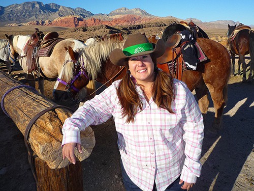 a cowgirl by her horse in Horseback riding Las Vegas