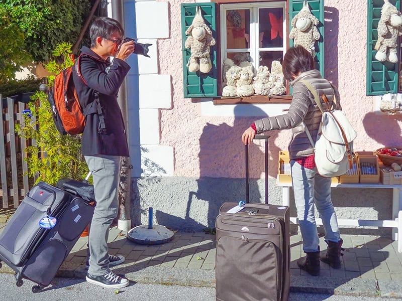 a man photographing a woman at a shop