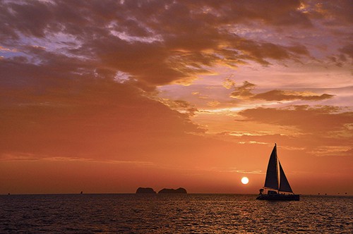 a boat on the water at sunset