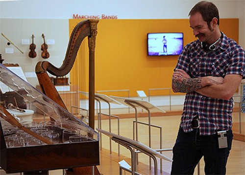 man at a music instruments exhibit