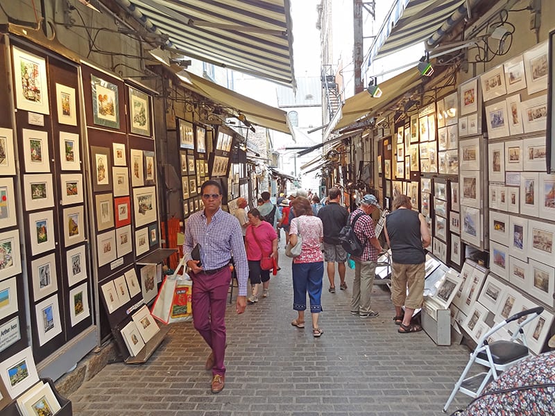 people walkinh through an outdoor art exhibit