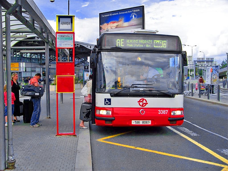 people boarding a bus at an airport