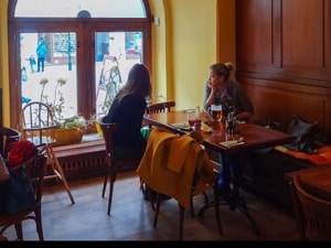 two young women sitting in a cafe in Prague in winter