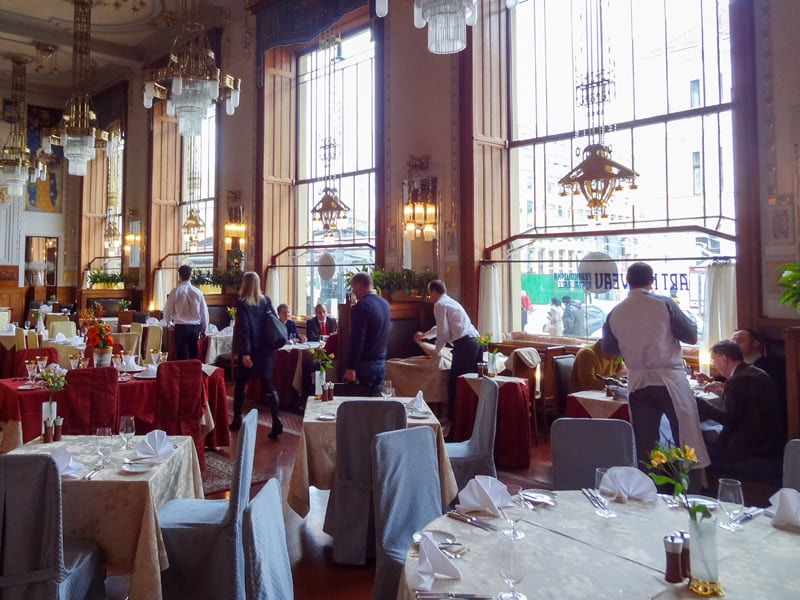 people in an ornate restaurant in Prague in winter