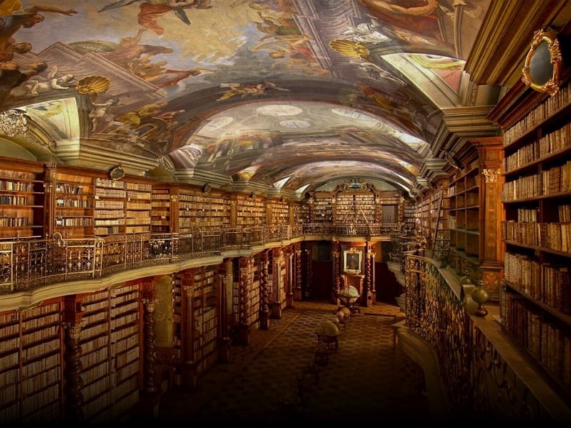 an old Baroque library with frescoes on the ceiling