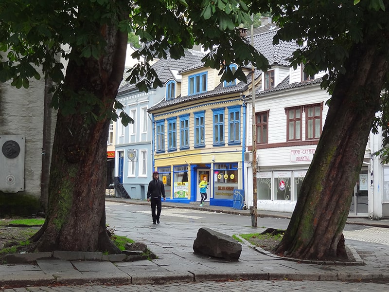 a man walking along a street reached from Bergen airport