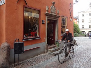 A man bicycling in the old town, one of the things to do in Stockholm