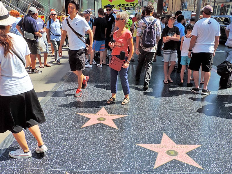 people walking on the Hollywood Walk of Fame, one of the popular things to do in LA