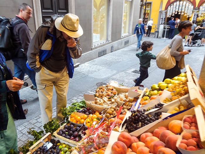 man in a market in the old city, one of the best things to do in Lugano Switzerland
