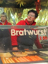 a woman selling bratwurst