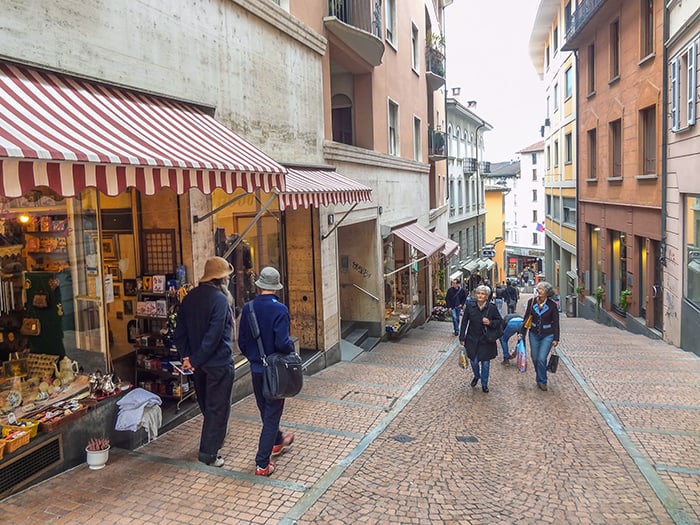 people walking on a street, one of the best things to do in Lugano Switzerland
