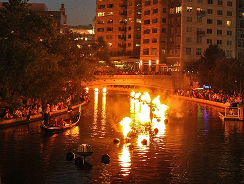 A gonola glides along a river during Waterfire in Providence Rhode Island