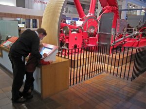 man by a museum exhibit