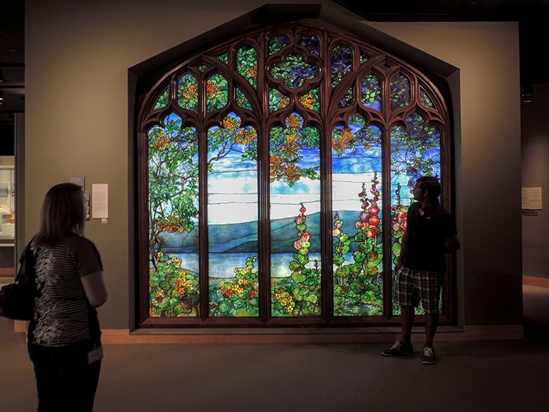 People looking at stained glass in one of the small museums in the U.S.
