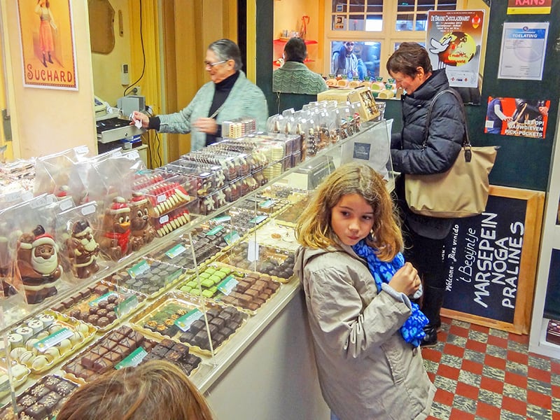 people in a shop buying Belgian chocolates