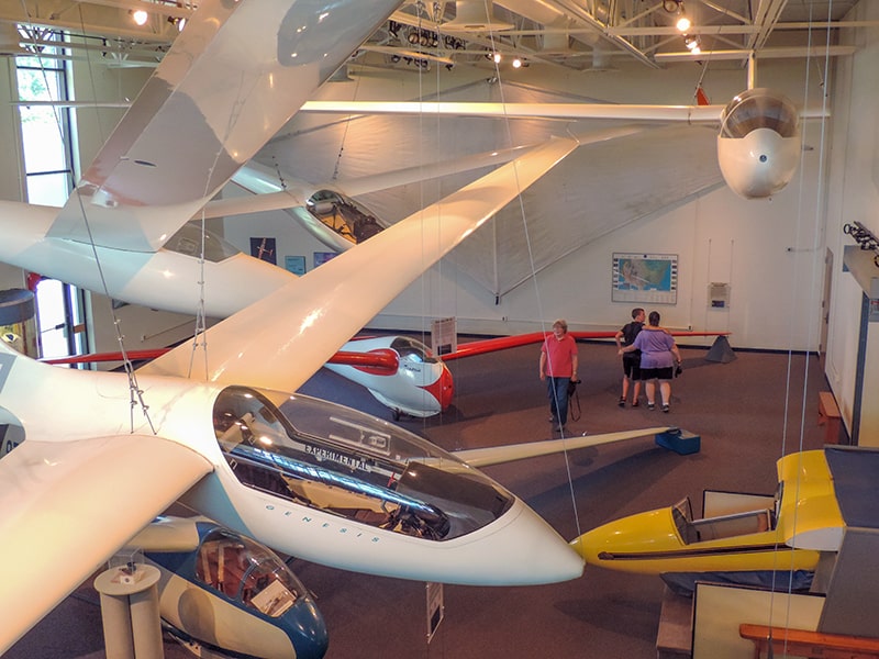 large gliders hanging from the ceiling in museum