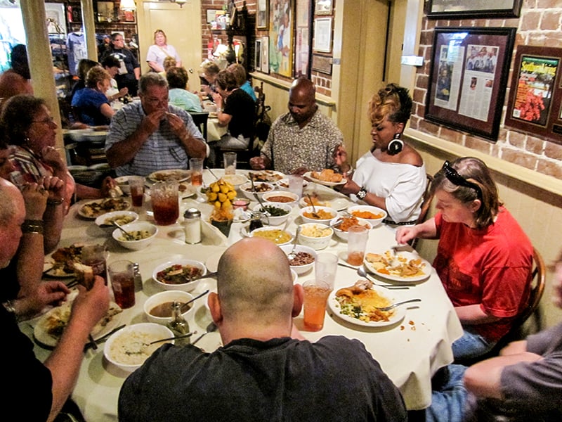 people at a table - one of the unique dining experiences in the US