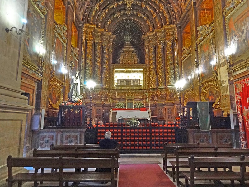 a woman in the chapel of The Convent of Santa Clara, one of the things to see in Coimbra