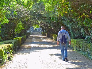 Man walking through the Gardens of the Quinta das Lágrimas hotel