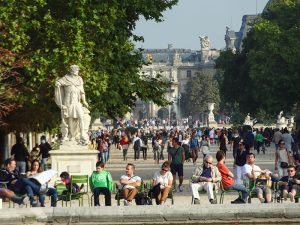 people sitting under a large statue in Paris