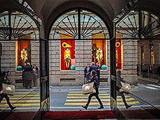 looking out a window at people walking along a street