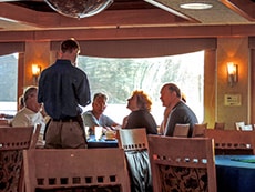 Passengers ordering dinner in a ship's dining room on a Sea of Cortez cruise