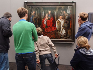 family looking at a painting in a museum