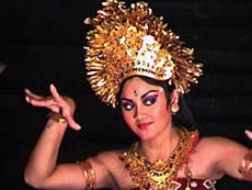 dancer with large headress moving her arms