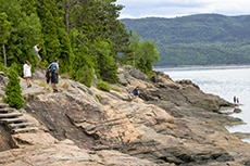 people on a rocky lake shore