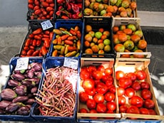 boxes of fresh vegetables at a stand