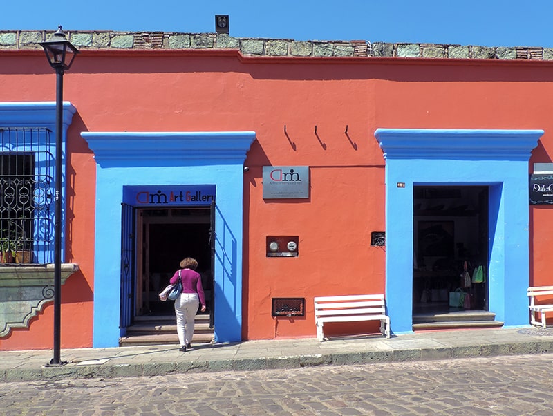 woman walking through a blue doorway