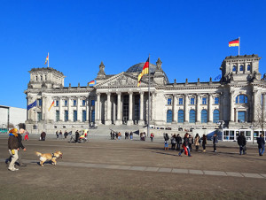 people walking in front of a large old building